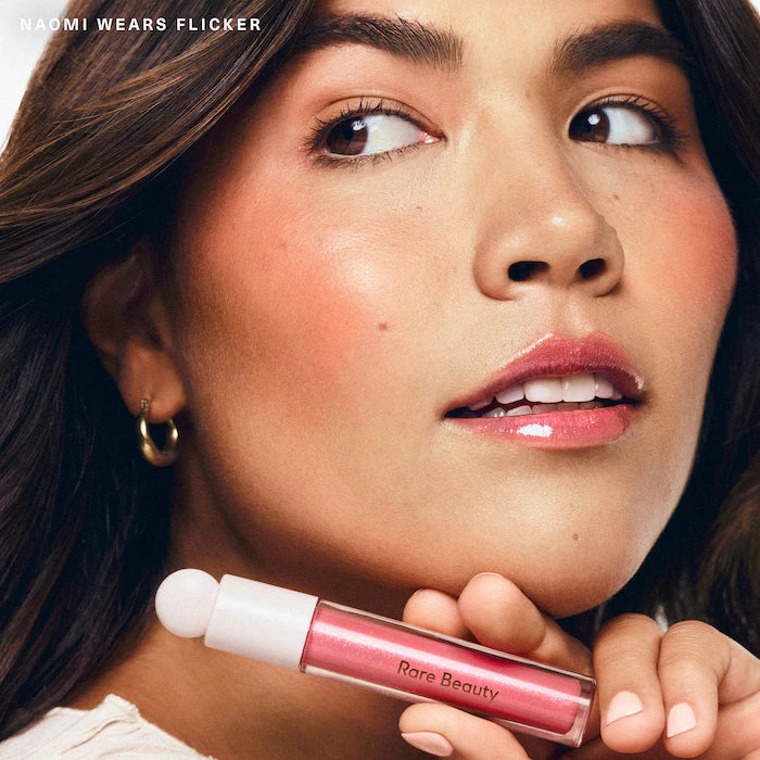 Rare Beauty by Selena Gomez
Positive Light Luminizing Lip Gloss Color: Flicker - pink with pink and blue pearl