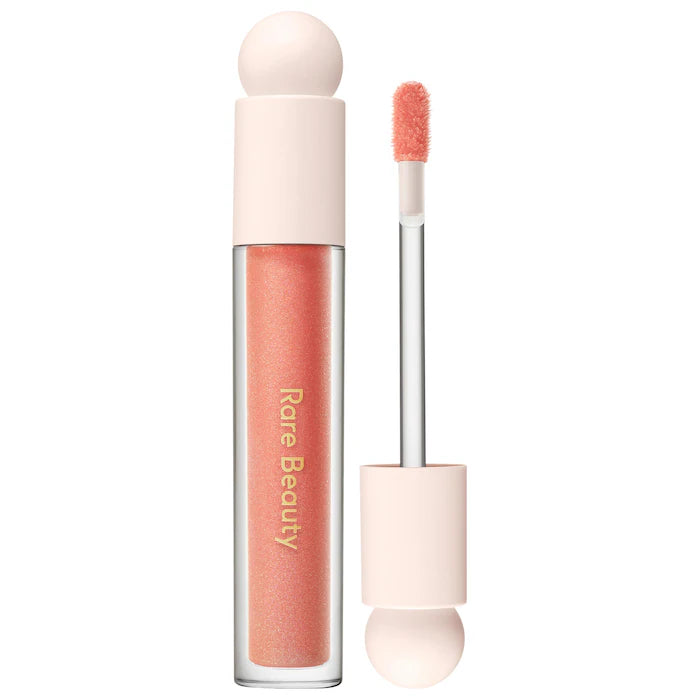 Rare Beauty by Selena Gomez
Positive Light Luminizing Lip Gloss Color: Beam - peachy coral with gold and pink pearl