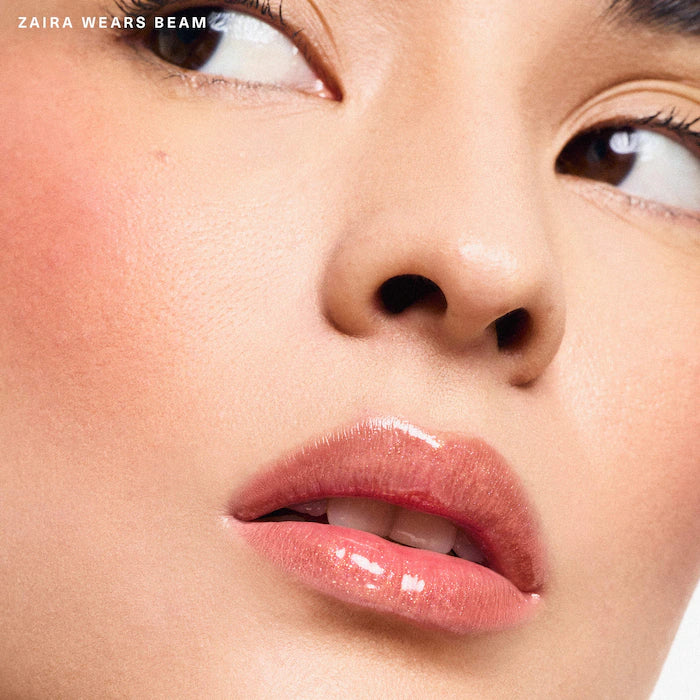 Rare Beauty by Selena Gomez
Positive Light Luminizing Lip Gloss Color: Beam - peachy coral with gold and pink pearl