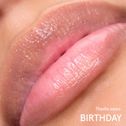 Glossier 
Balm Dotcom Lip Balm and Skin Salve Color: Birthday - soft shimmer clear