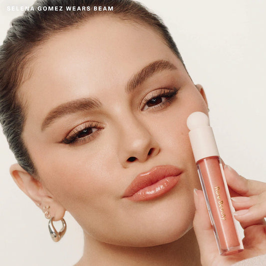 Rare Beauty by Selena Gomez 
Positive Light Luminizing Lip Gloss Color: Beam - peachy coral with gold and pink pearl